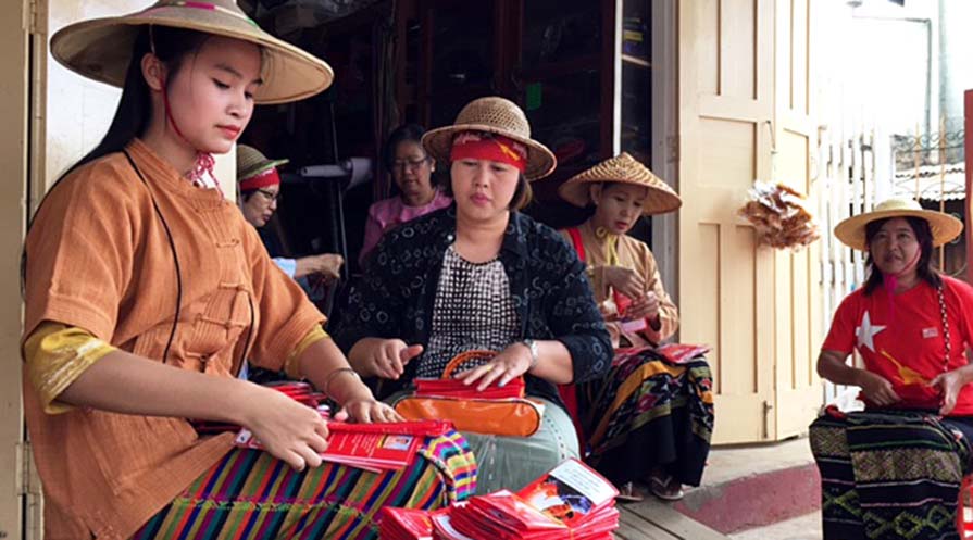 Photo of women organizing pamphlets.